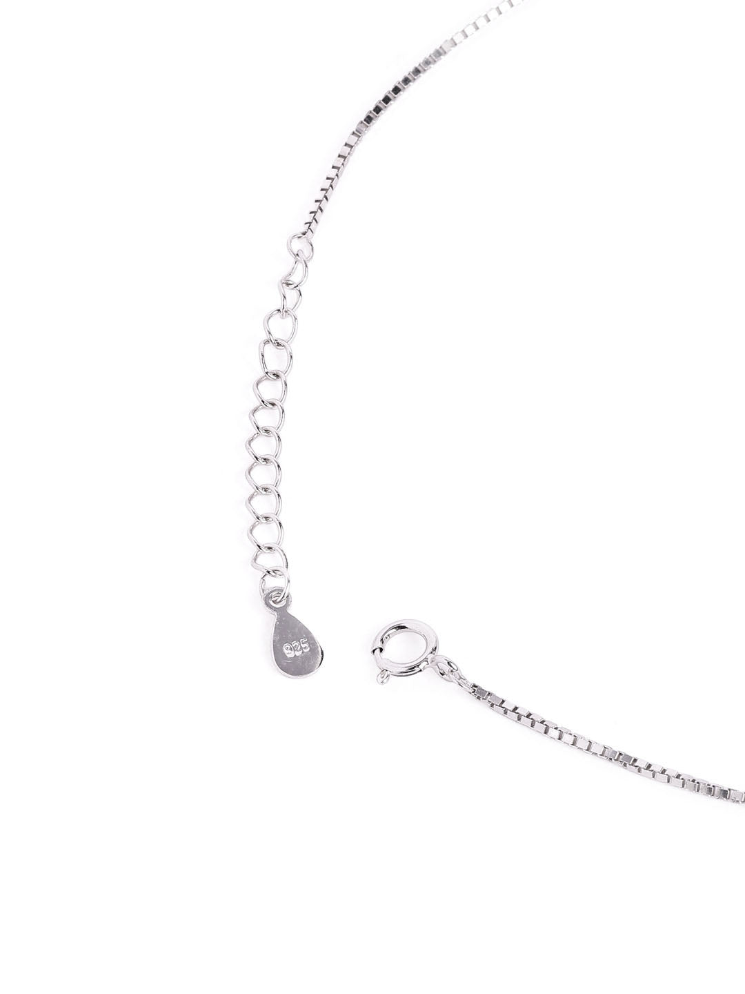 Mangal sutra and earrings set with evil eye-shaped charms on a white background