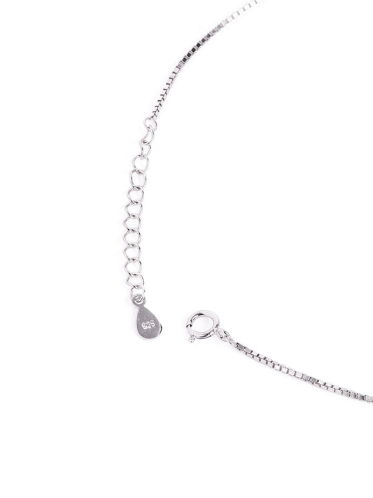 Mangal sutra and earrings set with evil eye-shaped charms on a white background